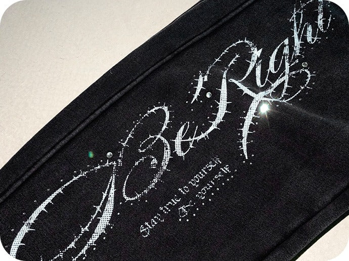 Close-up of the script print and rhinestones on the left leg